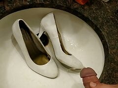 Filling white high heels with piss
