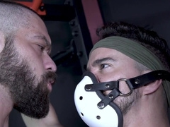 The jock is playing with the masked, submissive twink