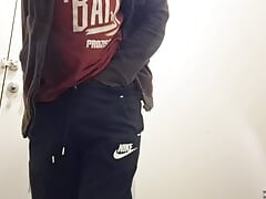 Sexy guy masturbating his big dick in a public bathroom