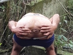 Guy in cutoffs and footwear undresses off and blows a load outdoors