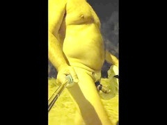 Chubby exhibitionist strolls through a summer night without clothes