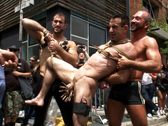 Muscular slave in a hardcore BDSM public bondage play