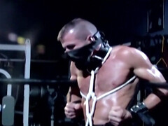 Muscular male slave is captive and set to endure merciless cock in ass