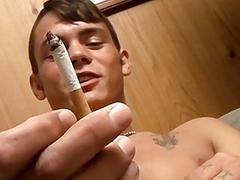 Horny lads smoke while they stroke each other