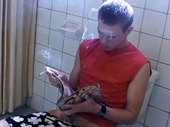 Twink tugs on his cock while smoking in the bathroom