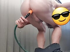 Using a garden hose to wash my ass outside hopefully someone will catch me