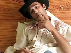 Gay cowboy smokes before stripping nude and stroking his boner