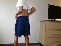 Asian showing off black shorts and blue underwear briefs