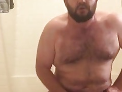 Bear jerks off while he ducks his dildo