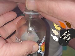 Chub pees in bottle with a hollow sound in his tiny cock and then plays with it a little.