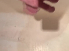 The man in the douche jacked off his gigantic hard-on and nutted