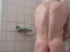 Muscle man take douche with cut hair