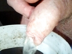 Close-up of John's cock when he is peeing in the waste bucket