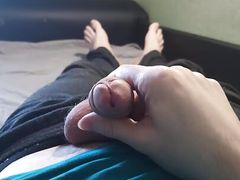 Guy in blue t-shirt jerking off his cock lying on the bed