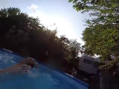 Cute twins wrestle naked in the pool